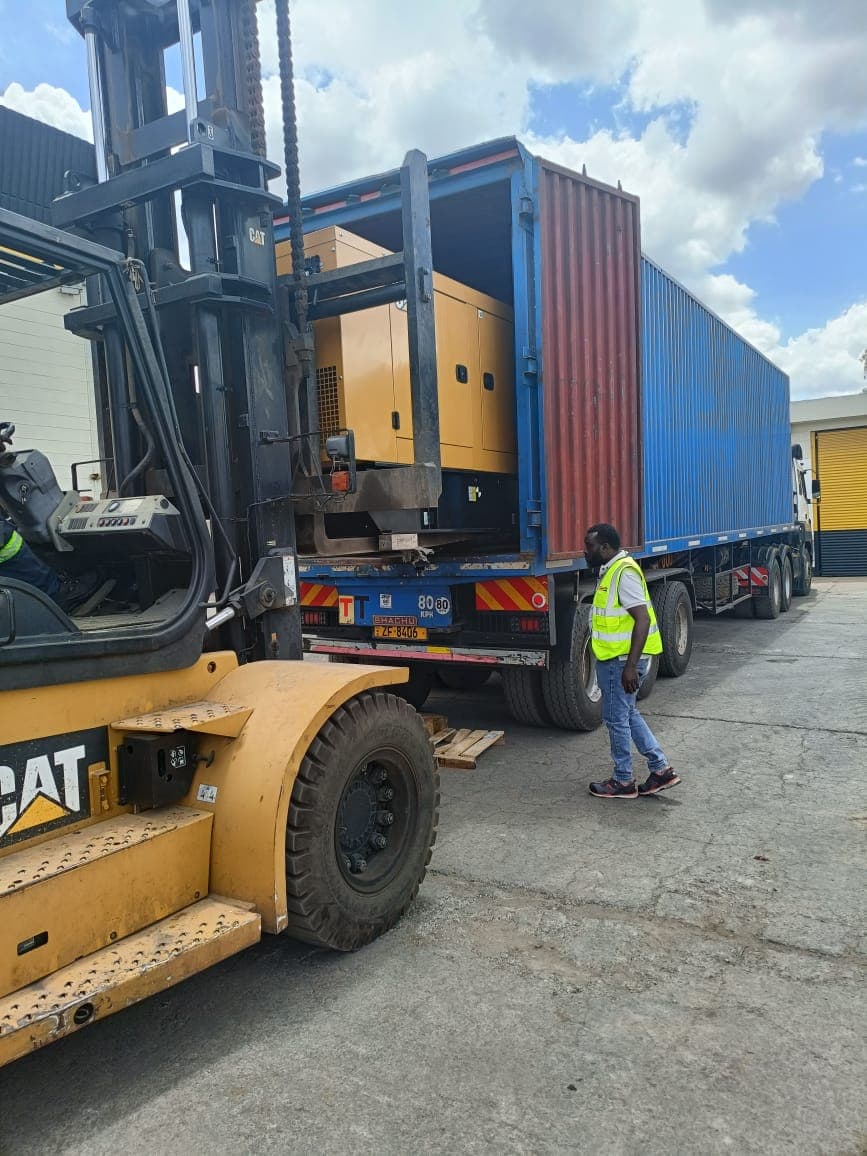 Forklift loading cargo into a container at the yard